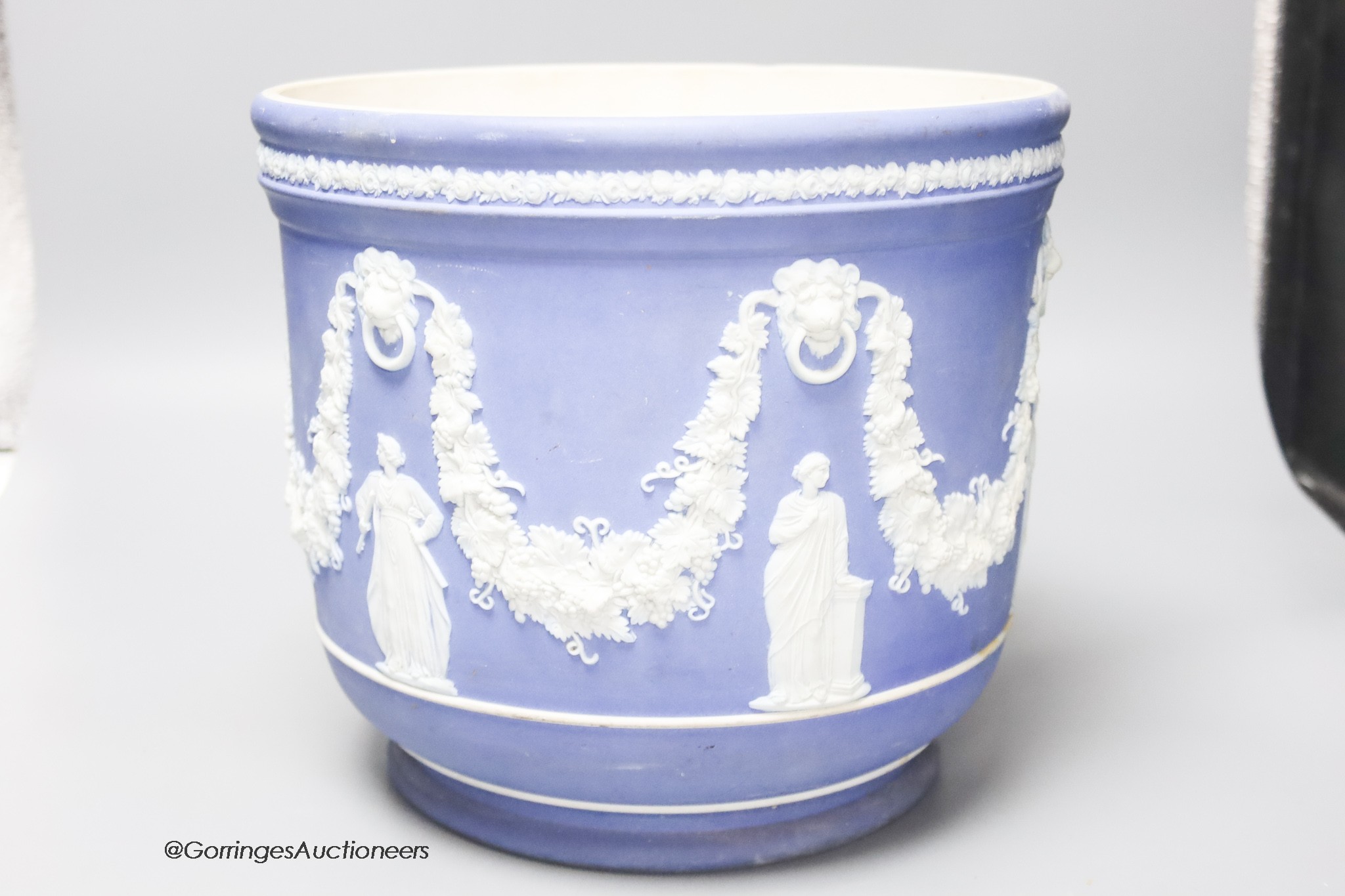 A Wedgwood blue jasper jardiniere, sprigged with muses and swags, height 23cm